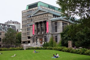 McGill university building with people sitting outside on the lawn