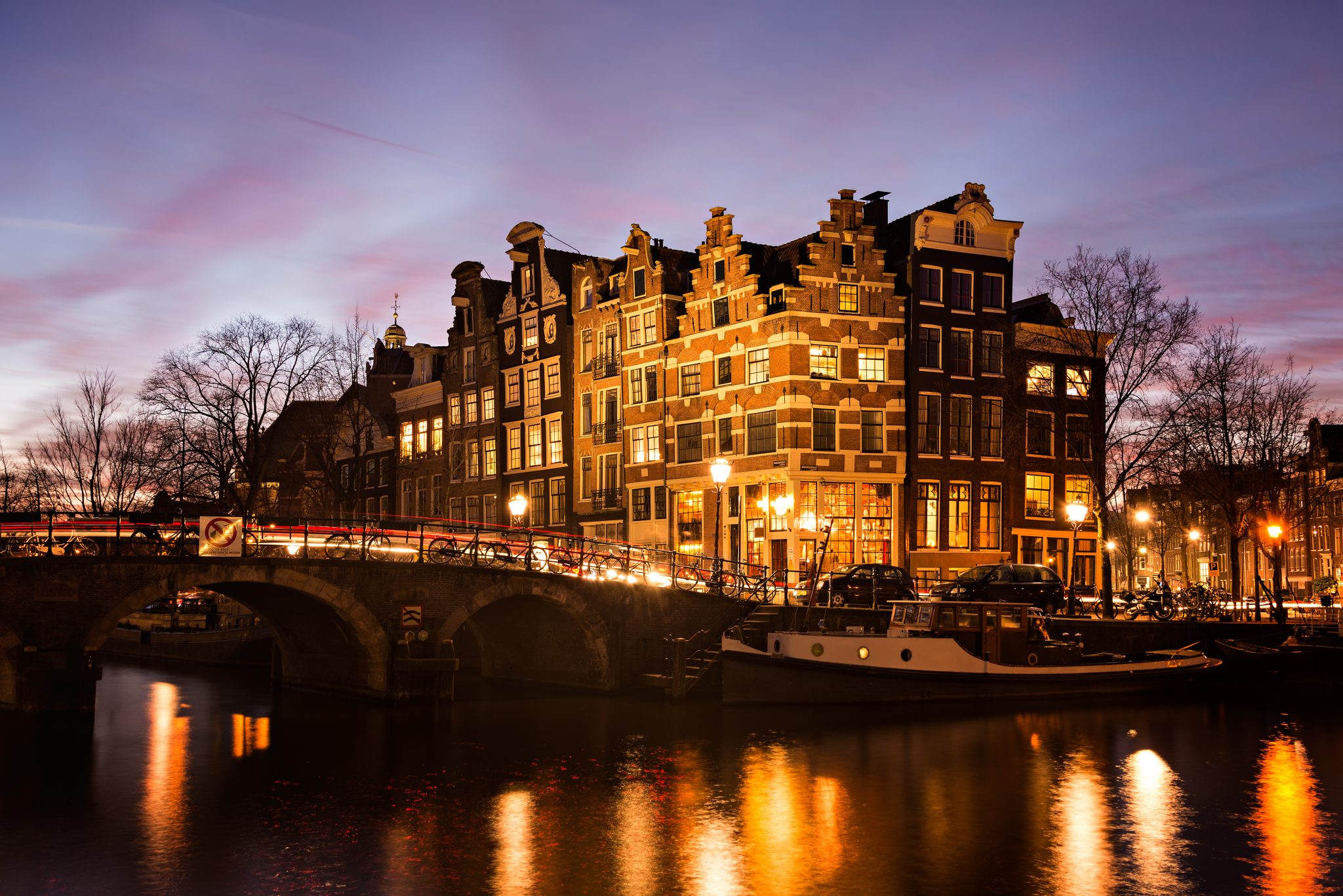 Amsterdam canal houses at dusk - WYSE Travel Confederation