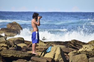 man taking photo of ocean in Australia 